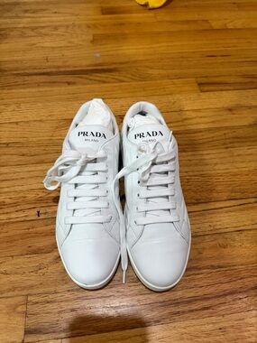 Prada white sneakers.